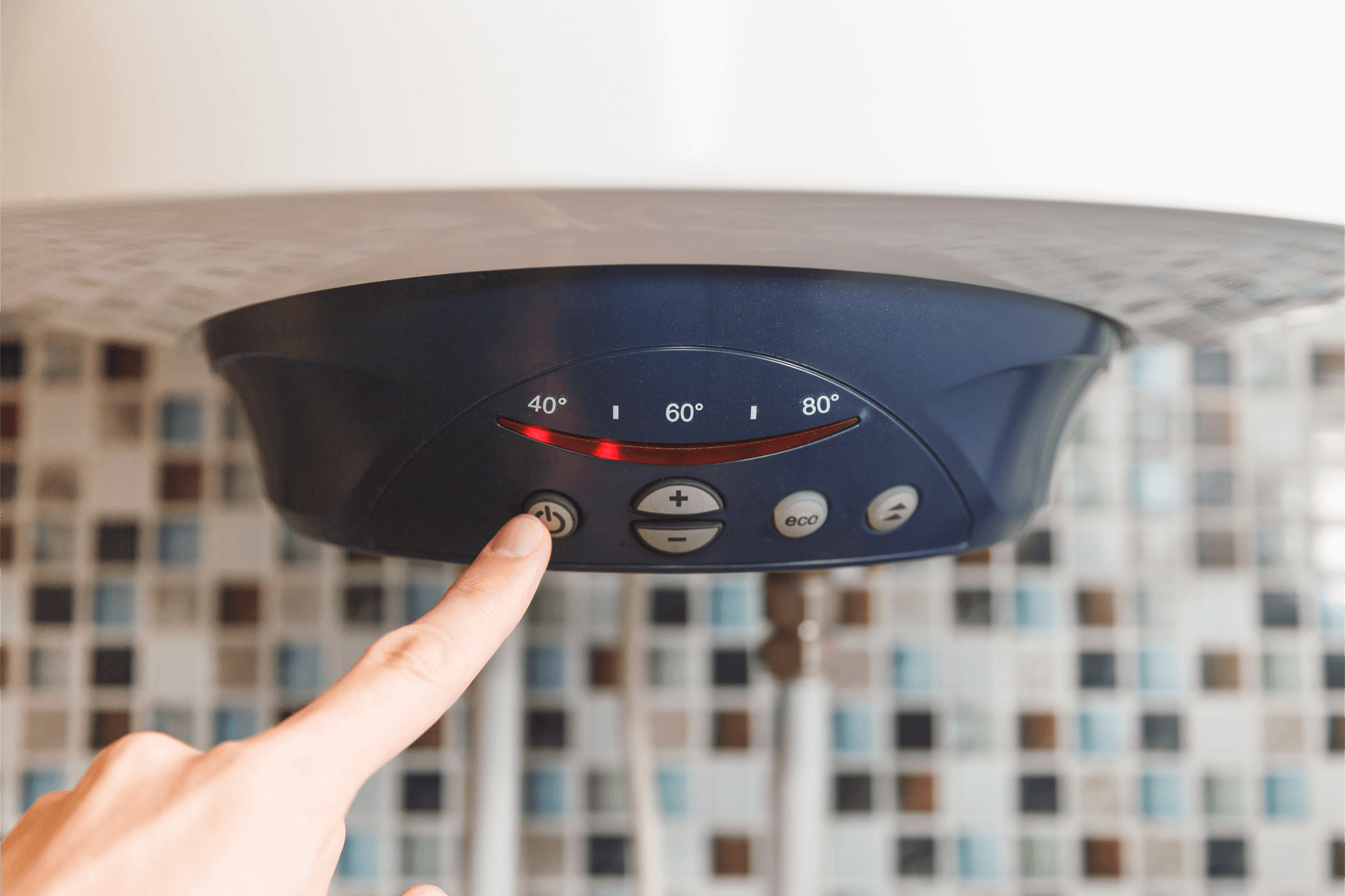 person pressing button on an electric boiler