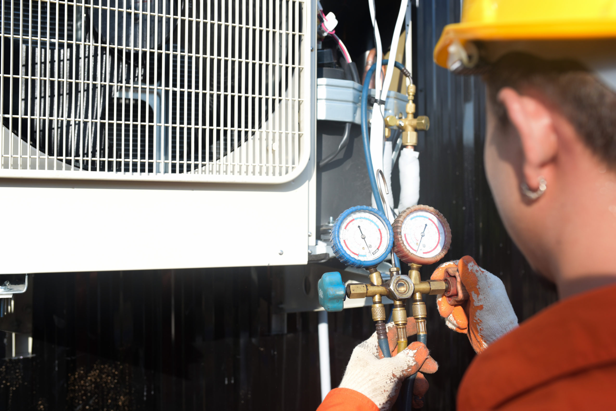 Technician conducting a gas safety check on commercial equipmen